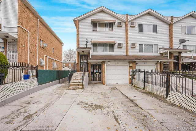 a view of a house with a barbeque and wooden stairs