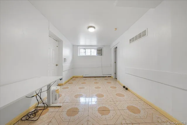 a picture of a bench in front of a wall