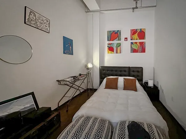 a bedroom with a bed and wall painting