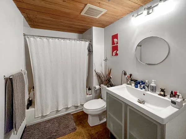 a bathroom with a sink mirror and toilet