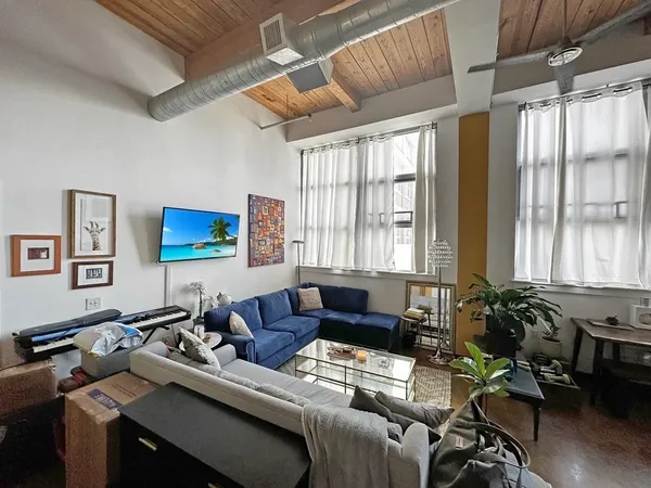 a living room with furniture and a flat screen tv