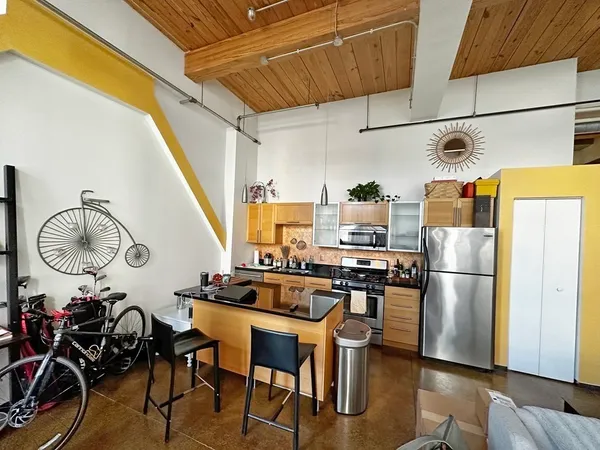 a kitchen with appliances cabinets and a table