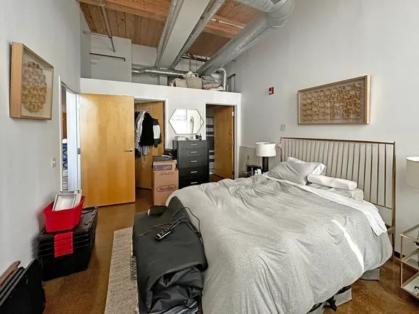 a bed room with a bed and a mirror