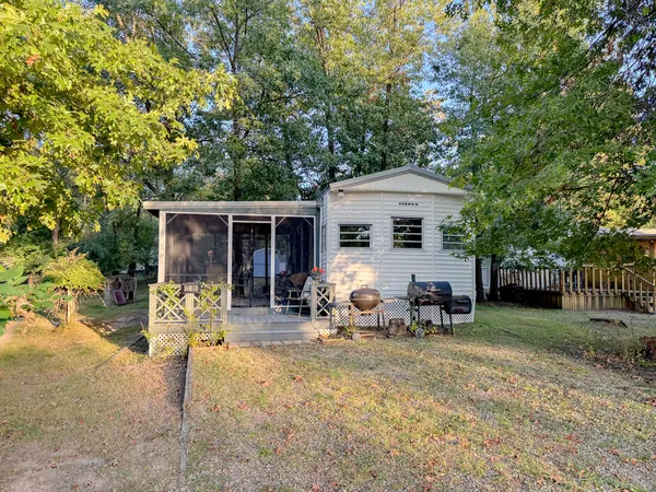 a view of a house with backyard porch and sitting area