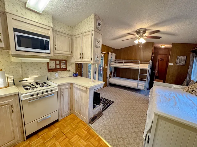 a kitchen with stainless steel appliances granite countertop a stove and a microwave