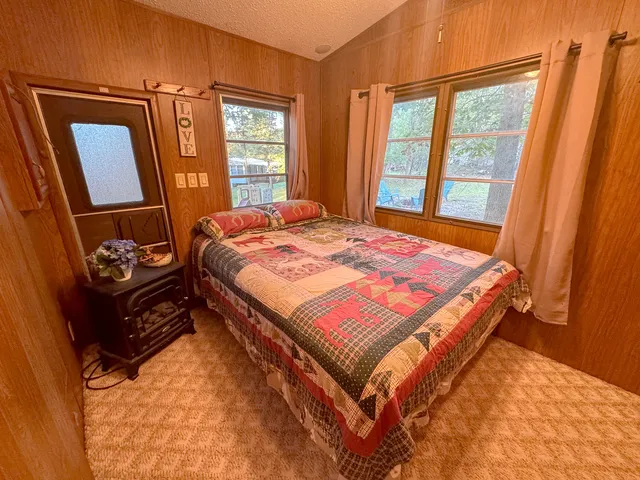 a bed sitting in a bedroom next to a window