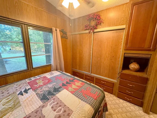 a bedroom with a bed and a dresser