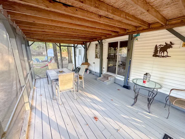 a view of a patio with table and chairs and wooden floor