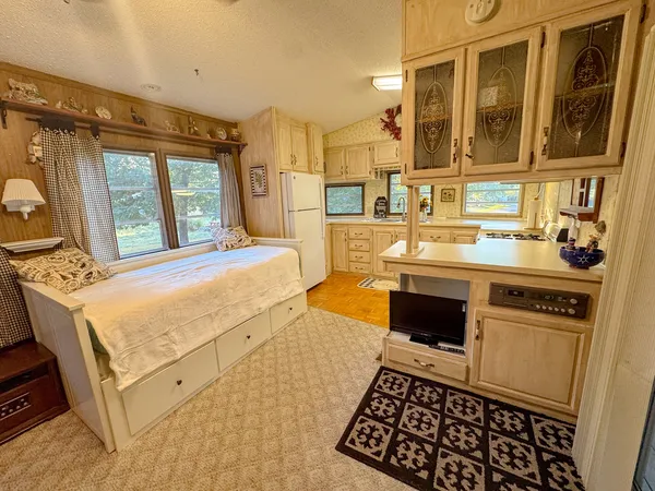 a large white kitchen with a stove a sink and a refrigerator
