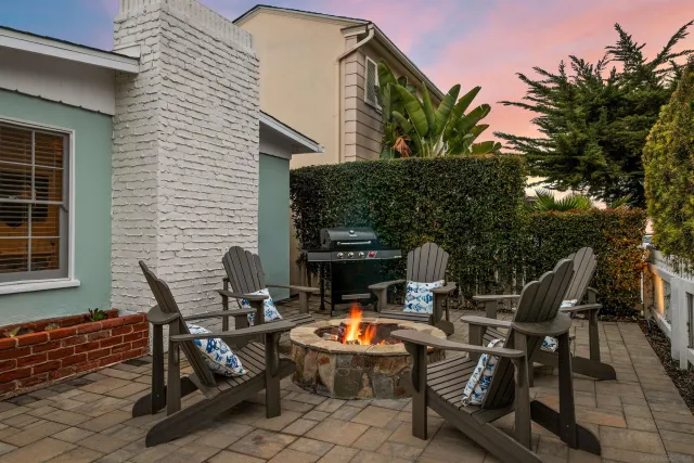 a view of a patio with table and chairs with wooden floor and fence