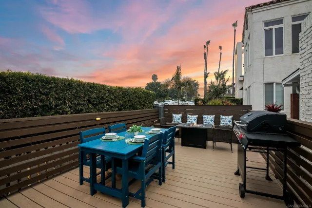 a view of a balcony with furniture and a potted plant