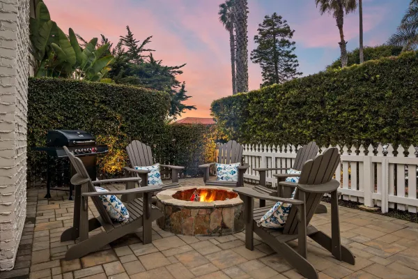 a view of outdoor sitting area with furniture and wooden fence