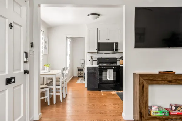 a kitchen with stainless steel appliances a stove top oven a sink and a refrigerator