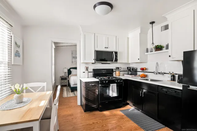 a kitchen with granite countertop a sink appliances and cabinets