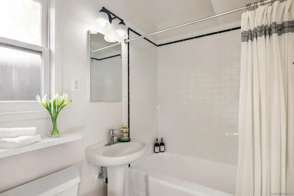 a bathroom with a sink a mirror and a shower