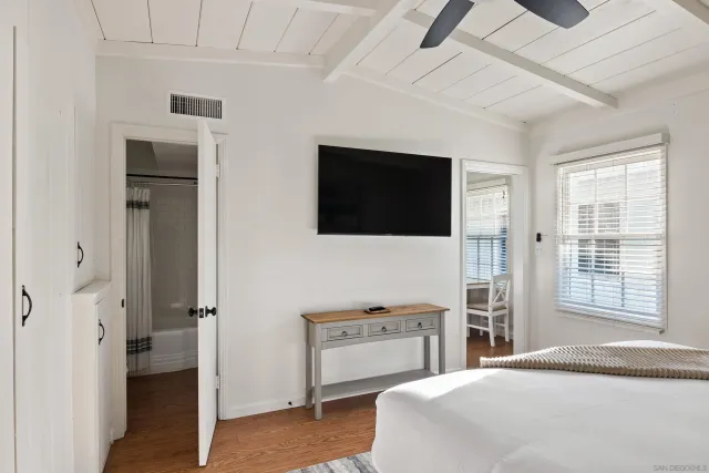 a bedroom with a bed and a flat screen tv