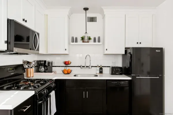a kitchen with stainless steel appliances a stove a sink and a refrigerator