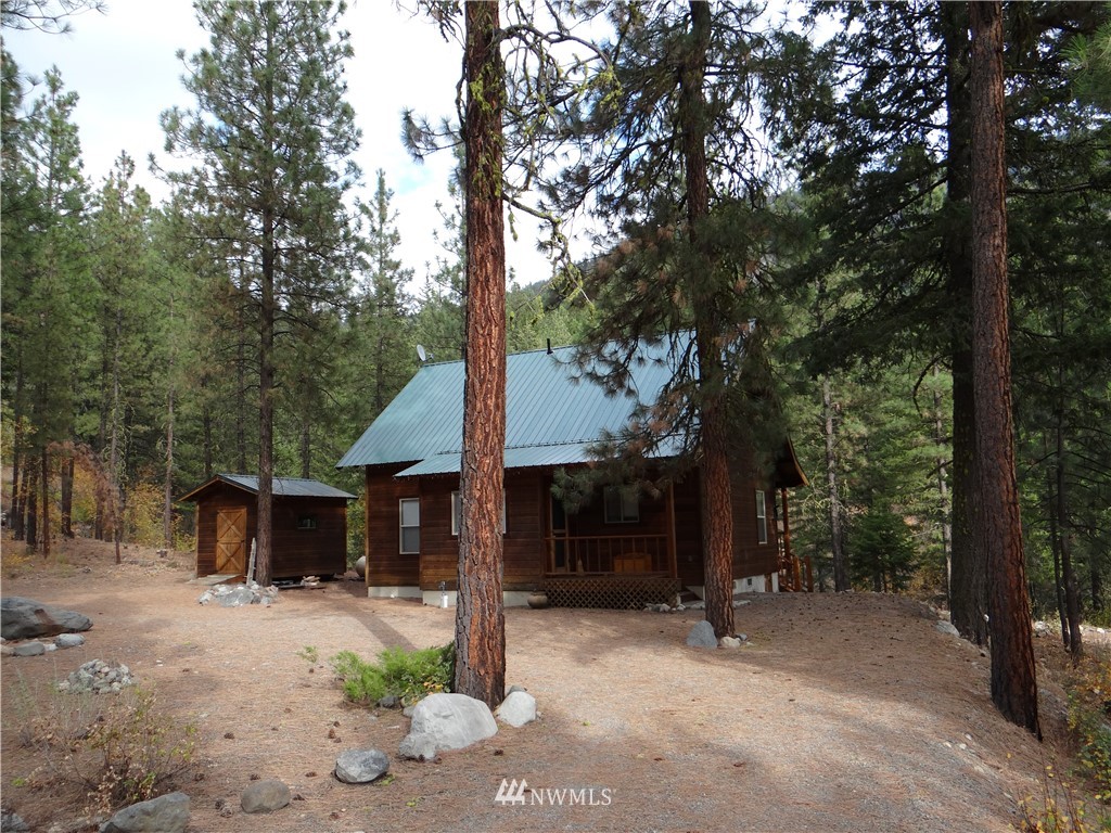 5 Bitterbrush Road Winthrop, WA 98862 - Photo 1 of 1 a view of a house with backyard and trees