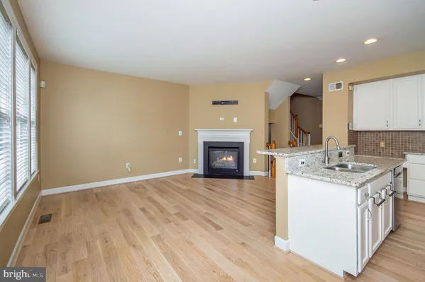 a kitchen with a sink and a stove top oven
