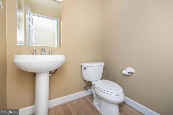 a bathroom with a sink a toilet and mirror