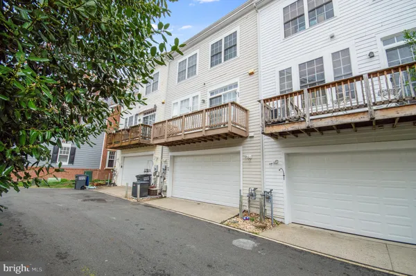 a view of a house with a garage and balcony