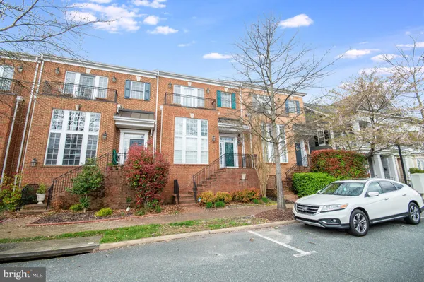 a car parked in front of a brick house