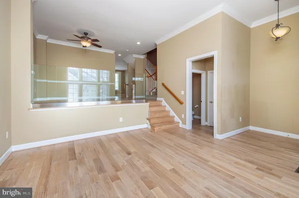 a view of a room with wooden floor and staircase