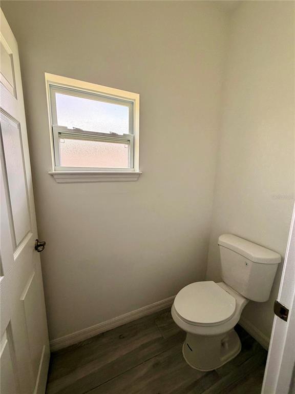 14142 Appleton Boulevard Port Charlotte, FL 33981 - Photo 13 of 26 a white toilet sitting next to a window