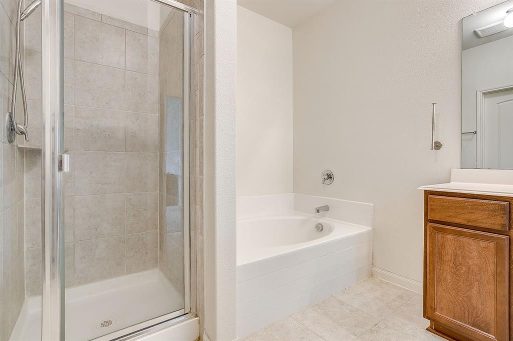 136 Kennedy Drive Venus, TX 76084 - Photo 13 of 27 a bathroom with a bathtub and a shower