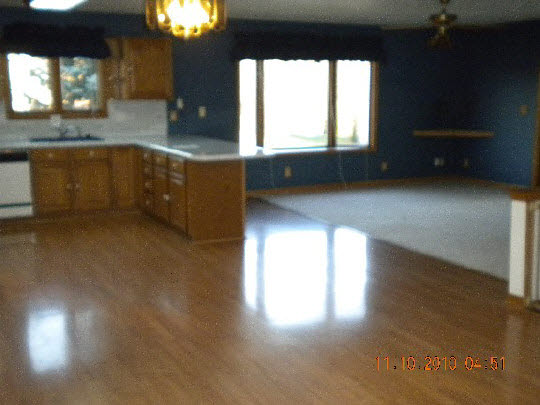 247 Rochester Road Northeast Poplar Grove, IL 61065 - Photo 2 of 7 a kitchen with a window a sink and a wooden floor