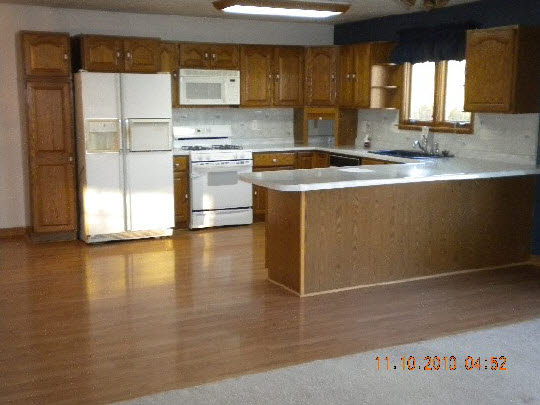 247 Rochester Road Northeast Poplar Grove, IL 61065 - Photo 3 of 7 a kitchen with stainless steel appliances granite countertop a sink and a stove