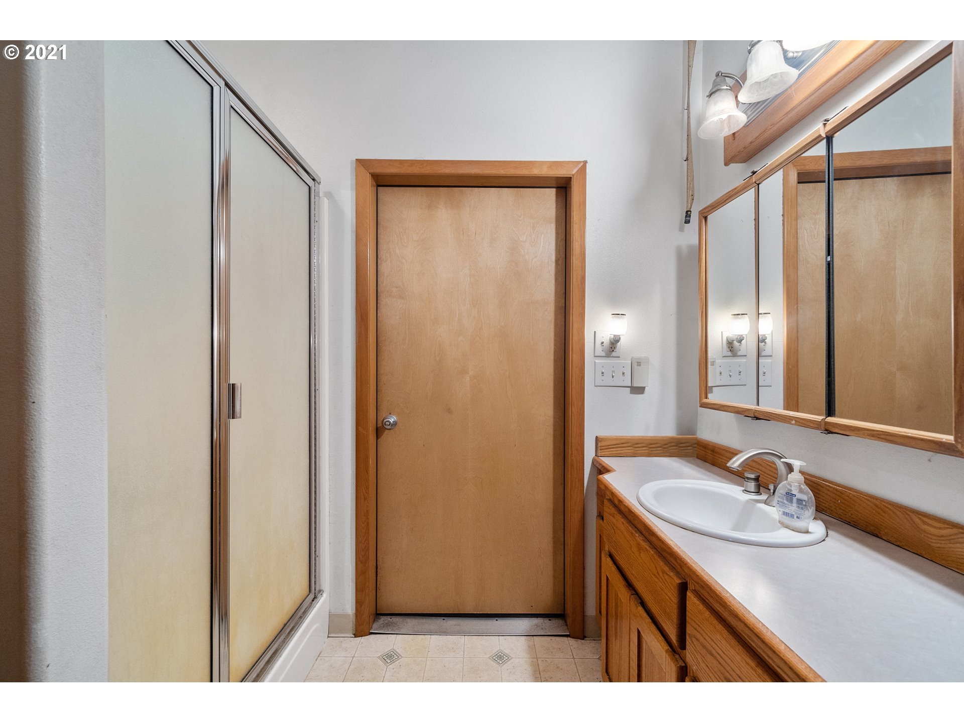 1220 McCormick Loop Road Tillamook, OR 97141 - Photo 13 of 30 a bathroom with a sink a mirror and a shower