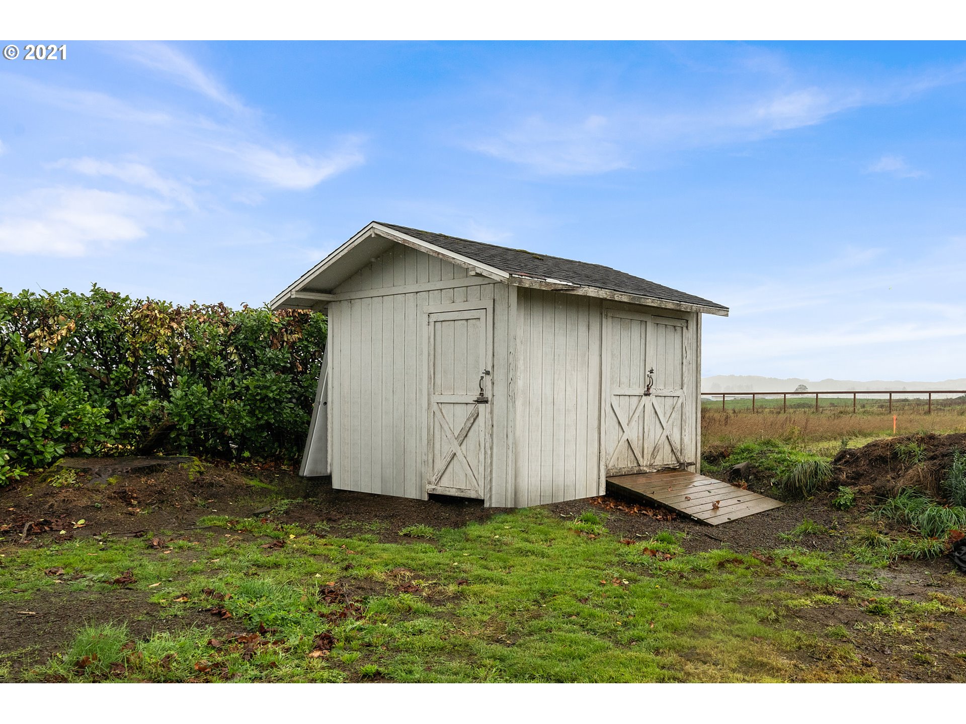 1220 McCormick Loop Road Tillamook, OR 97141 - Photo 10 of 30 a view of a backyard with barn plants and large tree