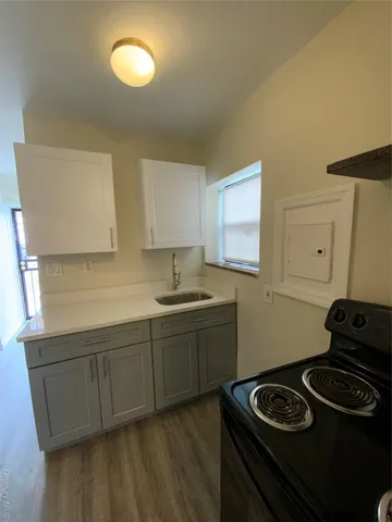 a kitchen with a sink and a refrigerator
