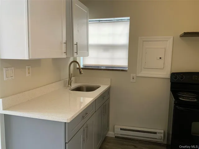a view of walk in closet with wooden floor