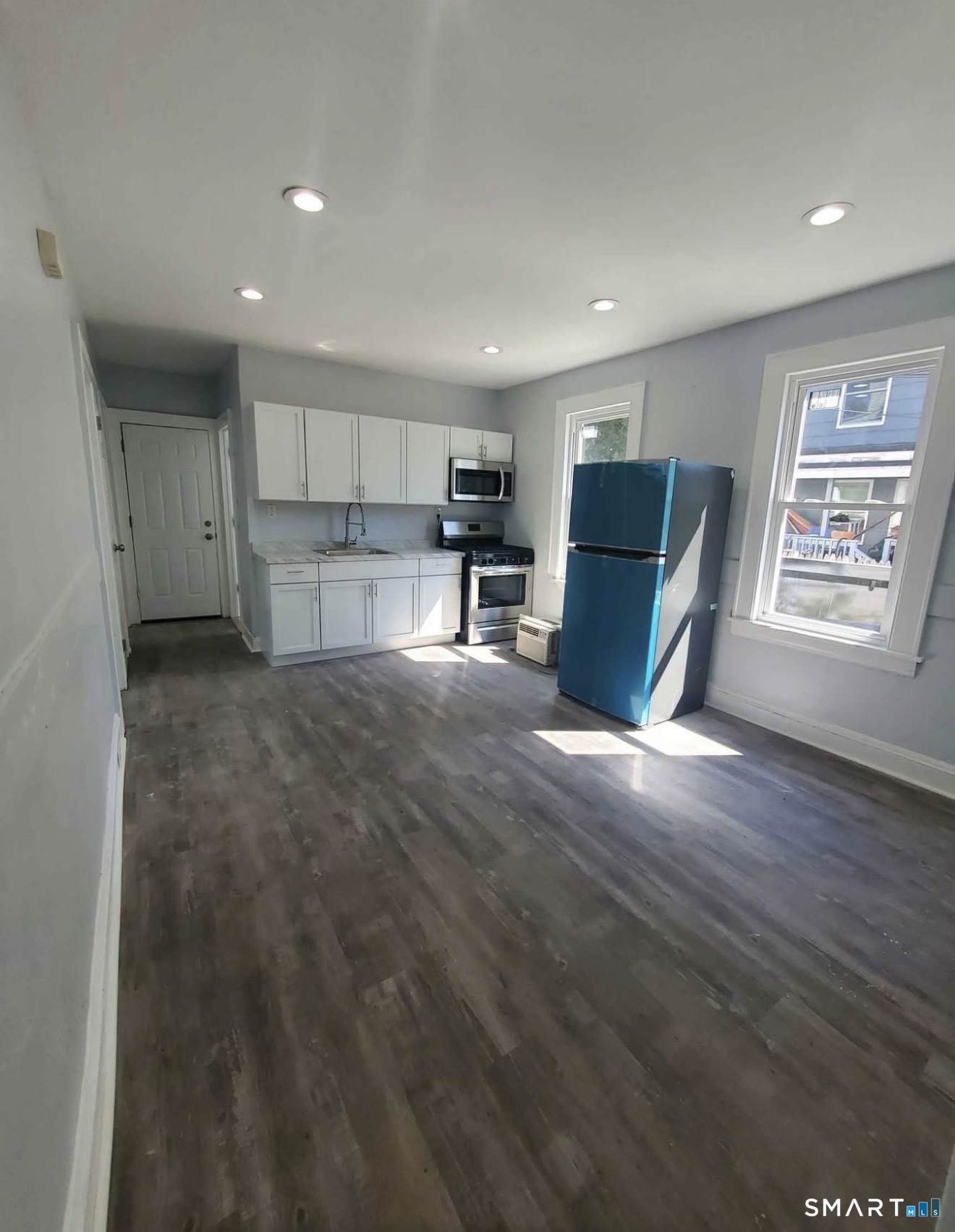 100 Horace Street Bridgeport, CT 06610 - Photo 2 of 8 a view of kitchen with kitchen island microwave and wooden floor
