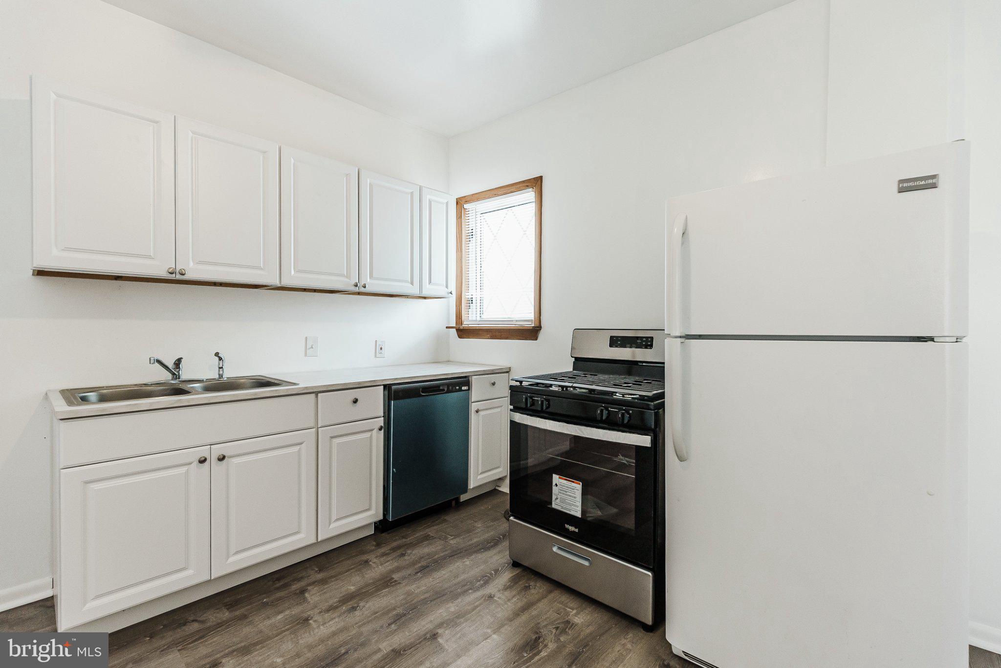 724 Moyer Street Philadelphia, PA 19125 - Photo 11 of 25 a kitchen with granite countertop a sink stove and cabinets