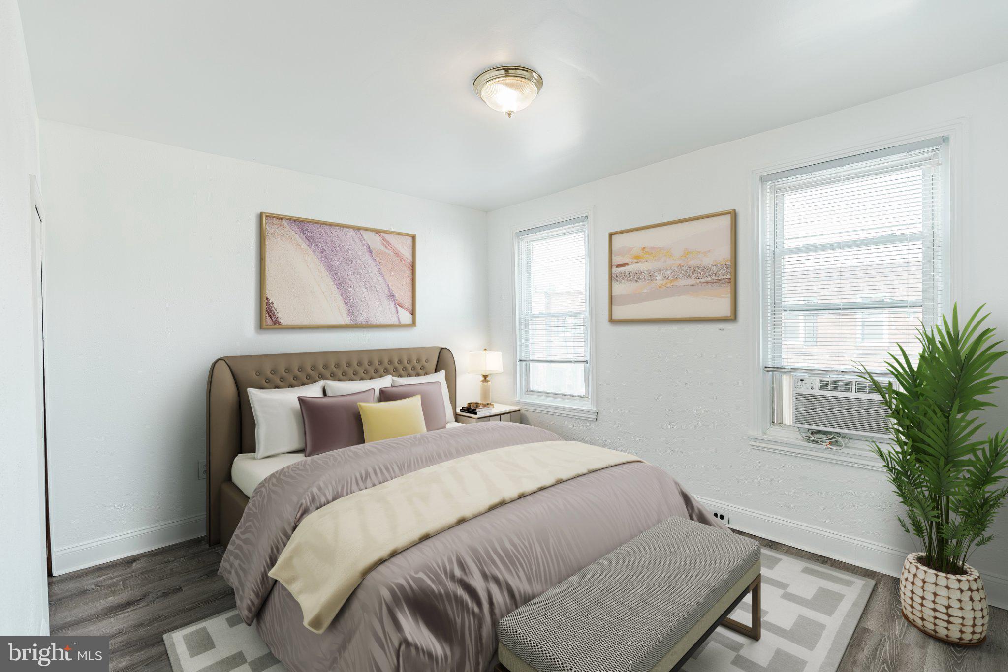 724 Moyer Street Philadelphia, PA 19125 - Photo 6 of 25 a bedroom with a large bed and a potted plant