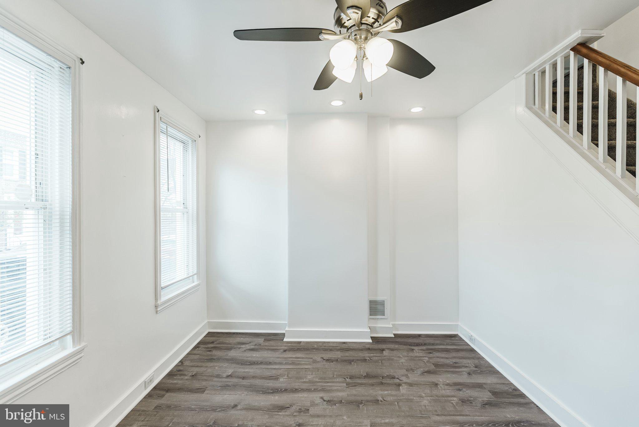 724 Moyer Street Philadelphia, PA 19125 - Photo 7 of 25 an empty room with wooden floor fan and windows