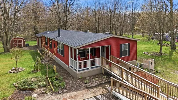 a view of a house with a small yard and wooden fence