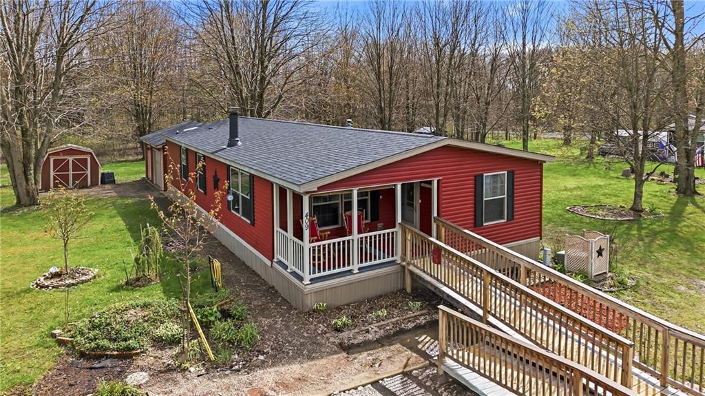 a view of a house with a small yard and wooden fence