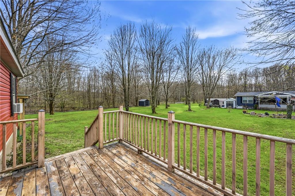 69 South Summit Road, Unit 409 Greenville, PA 16125 - Photo 34 of 41 a view of a deck with large trees and wooden fence