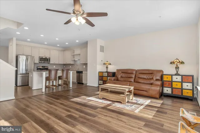 a living room with furniture and kitchen view