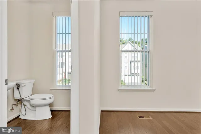 a bathroom with a toilet sink and window