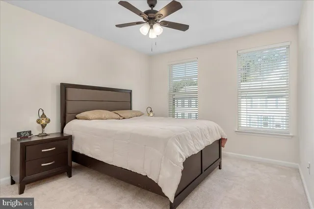 a bedroom with a bed and a ceiling fan