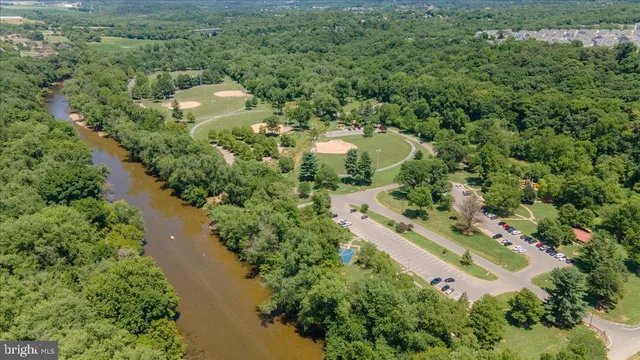 a front view of a house with a garden and parking space