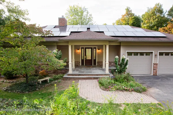a front view of a house with garden