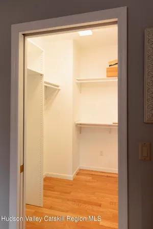 a living room with furniture a flat screen tv and floor to ceiling window