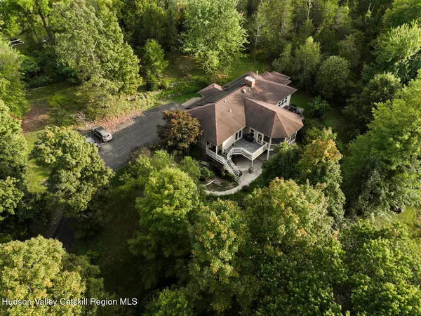 a view of a house with a backyard and a tree