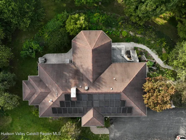 a view of a house with a yard and pathway